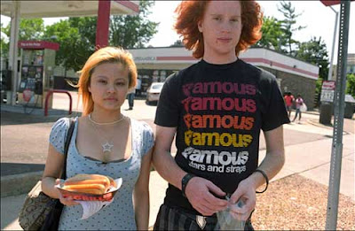 High school age girl and boy at a gas station, color photo