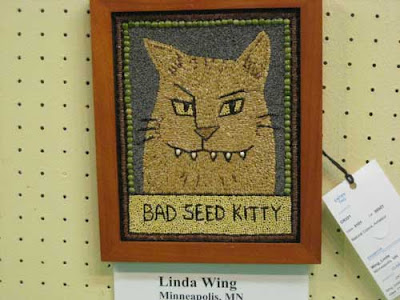 Tan cartoon cat with sharp fangs, labeled Bad Seed Kitty