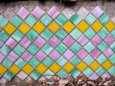 Orange, pink and green square tiles in a harlequin pattern