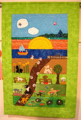 Large wall hanging in green and other bright colors with dogs in a naturalistic setting