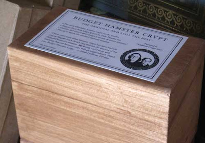 Wooden box with a lid labeled Budget Hamster Crypt