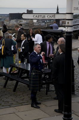 Outdoor reception with man in kilt and sign saying Castle Cafe