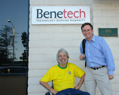 Scott Rains wearing Brazill football jersey and Jim Fruchterman, under the Benetech office sign