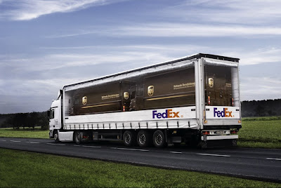 photo of a fedex truck seemingly hauling ups trucks