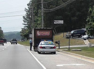 photo of a cop stopping a donut truck