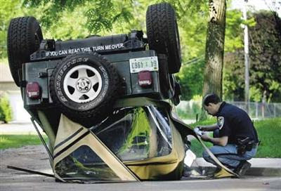 photo of an upside-down car with appropriate bumper sticker