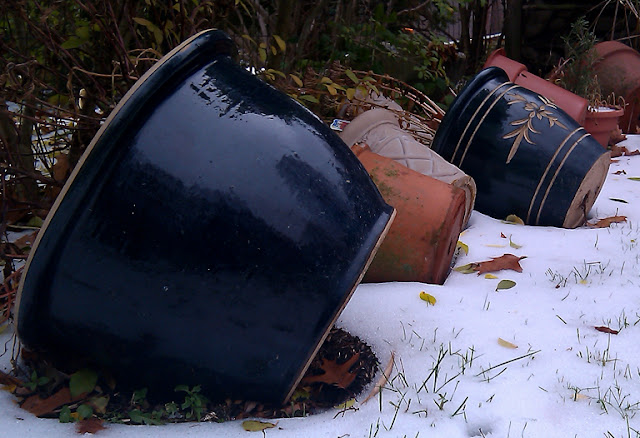 Flower pots on their sides and the first snow of the season in Stephentown, NY