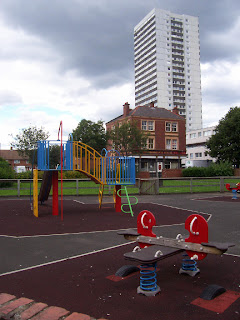 A childrens playground, The Harrogate House pub and Shieldfield House behind