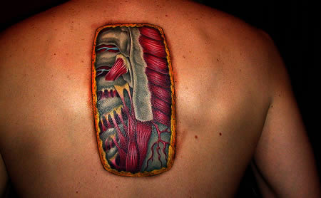 tattoo cute20. This tattoo represents a nice chunk of skin removed to reveal the anatomy