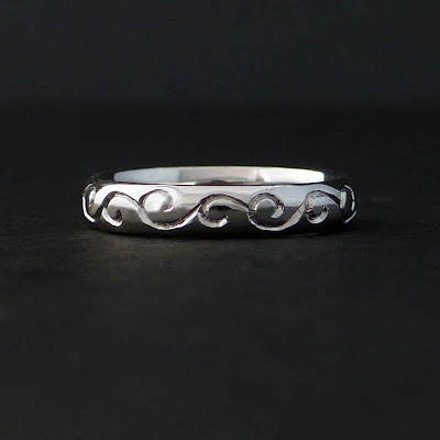 Her band is platinum with the hand engraved Koru pattern