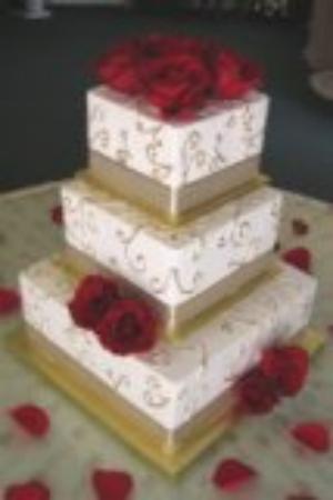 Three tiered square wedding cake with hidden pillars
