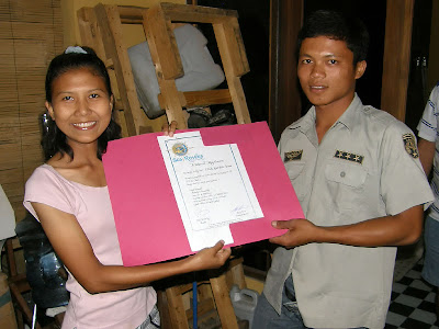 Ditta presents Budi with his certificate