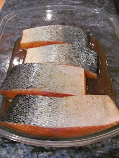 Marinating salmon for grilling in a glass dish.