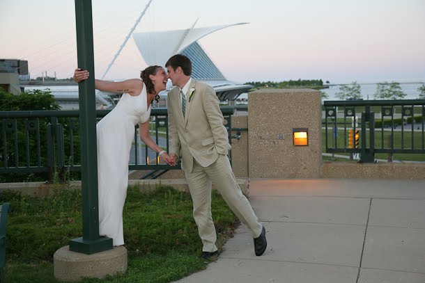 John and Ellie kissing at sunset during their wedding by the Calatrava Art Museum