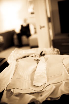 Groom's tuxedo laid out on bed in Courtyard Marriott