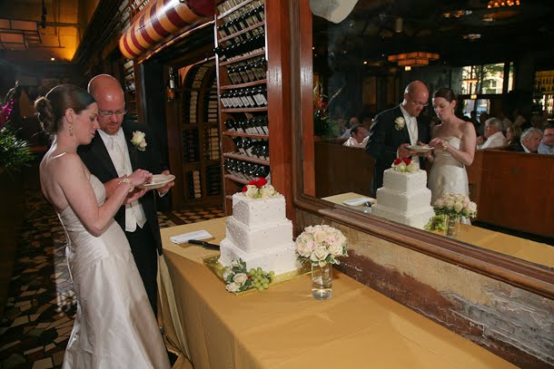 Bride and groom eating wedding cake at Scoozi restaurant