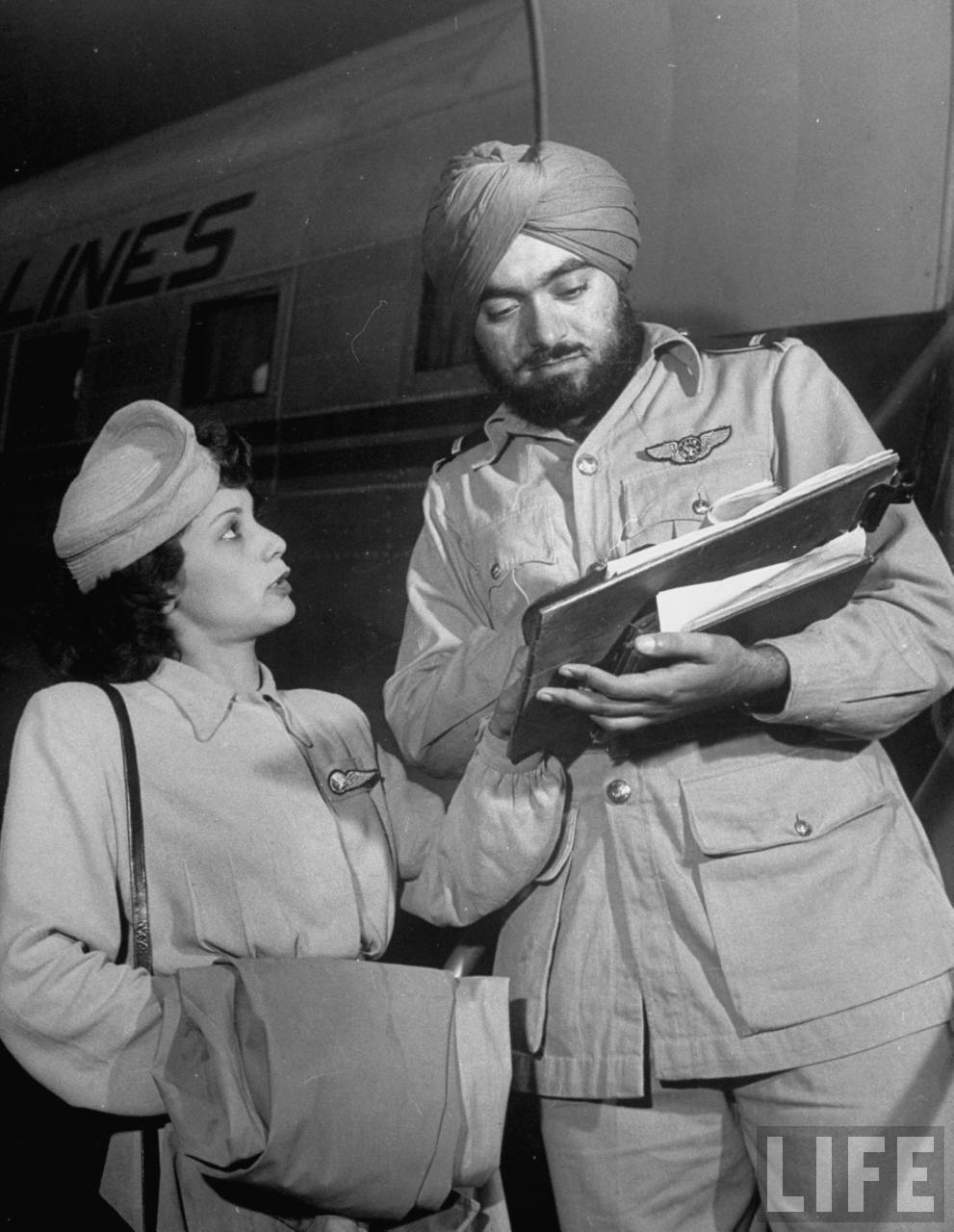 Air India flight attendant Monica Gilbert (L) collecting autograph of publicity dir. Qasi Isa after flight. Air India flight attendant Monica Gilbert (L) collecting autograph of publicity dir. Qasi Isa after flight.