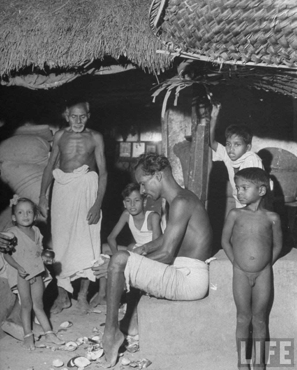 Indian Father of the Untouchables Caste, with his Children & his Father in their Hut - Poodalur India 1946