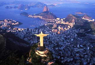 Backside aerial night evening view of Christ the redeemer statue in lighting near the bay