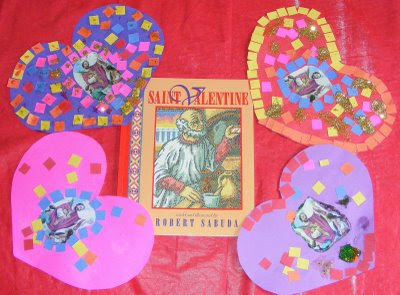 Paper hearts with pictures of Saint Valentine around Saint Valentine book