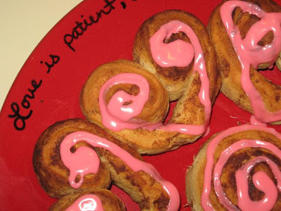 Heart cinnamon rolls with pink frosting.