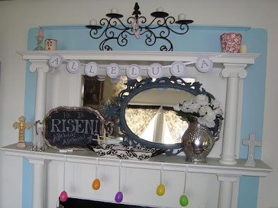 Mantel with mirror, crosses, black board, and garlands