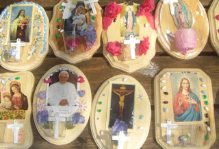 Holy water fonts decorated with beads and religious symbols