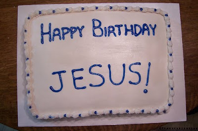 White cake with blue lettering reading "Happy Birthday Jesus!"