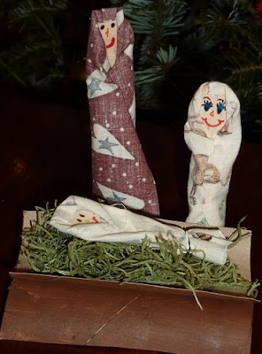 Nativity scene with baby Jesus, Mary, and Joseph made with toilet paper rolls and wrapping paper