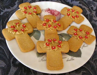 Gingerbread cookies in cross shapes with flower wreath designs on them