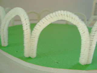 White pipecleaner made into fence arches