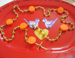 Finished edible rosary on plate with bird pattern