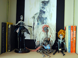 three dolls in a row near the Lady Death