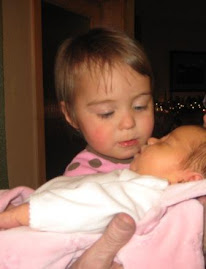 Savannah giving her sister kisses
