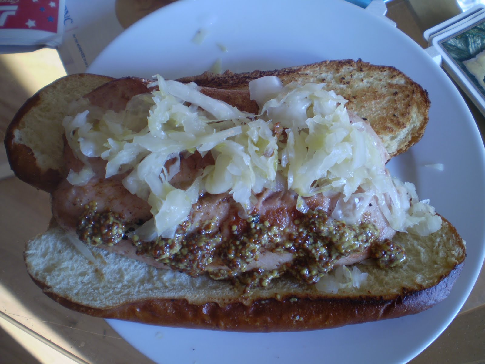 KING BOLETUS Pork and veal hot dog on a pretzel roll with sauerkraut