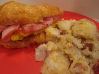 Breakfast Croissant and Potatoes is croissants filled with egg, cheddar cheese and ham with a side of red potatoes covered in seasoned salt and pepper. Life-in-the-Lofthouse.com