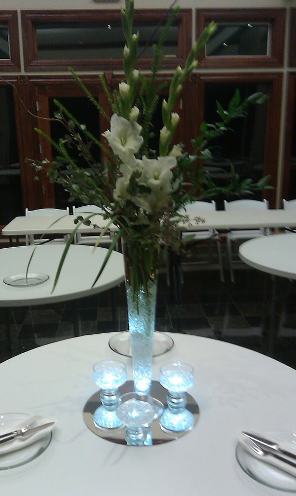 An arrangement of white gladiolus lily grass seeded eucalyptus and Italian 