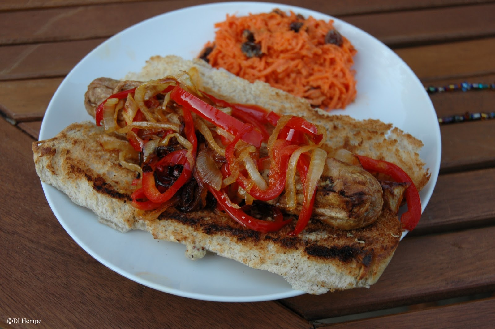 Smart Cooking Brats on the Grill Topped with Caramelized Onion and Peppers