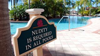 Nudity is required in all pools sign.