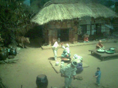 Section of a diorama of village life showing the preparation of Korean sauerkraut