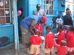 [Ken+Okoth+giving+out+the+balls+to+the+kids+to+play+with+looking+on+is+the+Centers+Acting+Director..JPG]