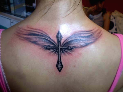 cross and angel tattoo on the back