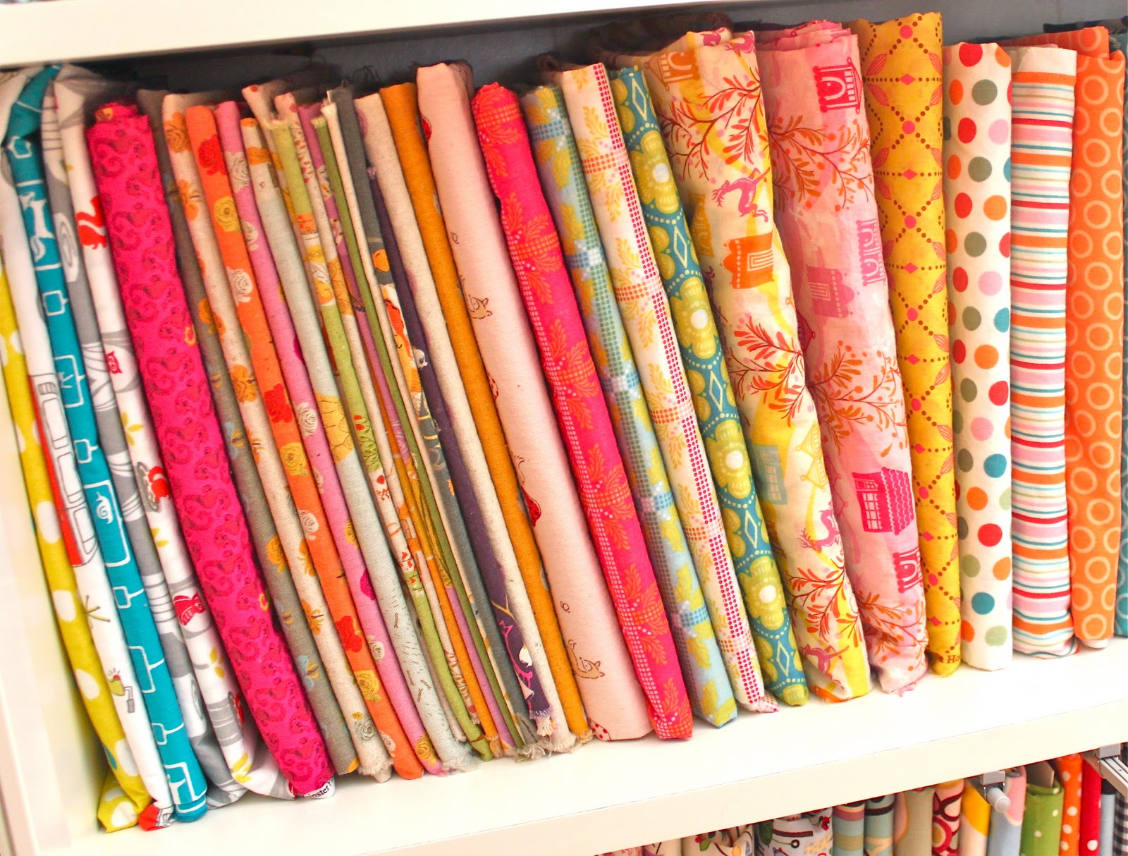 Fabric storage using Ikea Billy shelves and comic book boards to wrap the  fabric