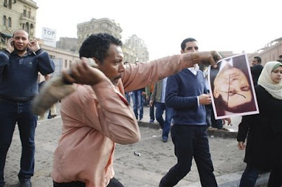 Protester Hits Mubarak Upside-down Photograph With a Shoe