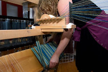 Winding fiber to back of loom