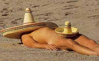 nude man sombrero at the beach