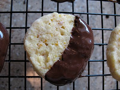 A photo of a toasted coconut orange icebox cookie on a wire cooling rack.