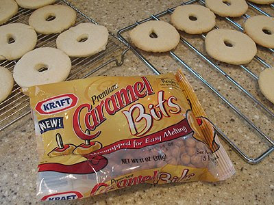 A photo of a bag of Kraft caramel bits and cookies resting on cooling racks in the background.