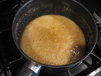 A photo of water and sugar in a large, heavy bottomed saucepan.
