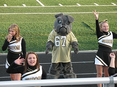 A photo of the mascot Spike hanging with the cheerleaders.